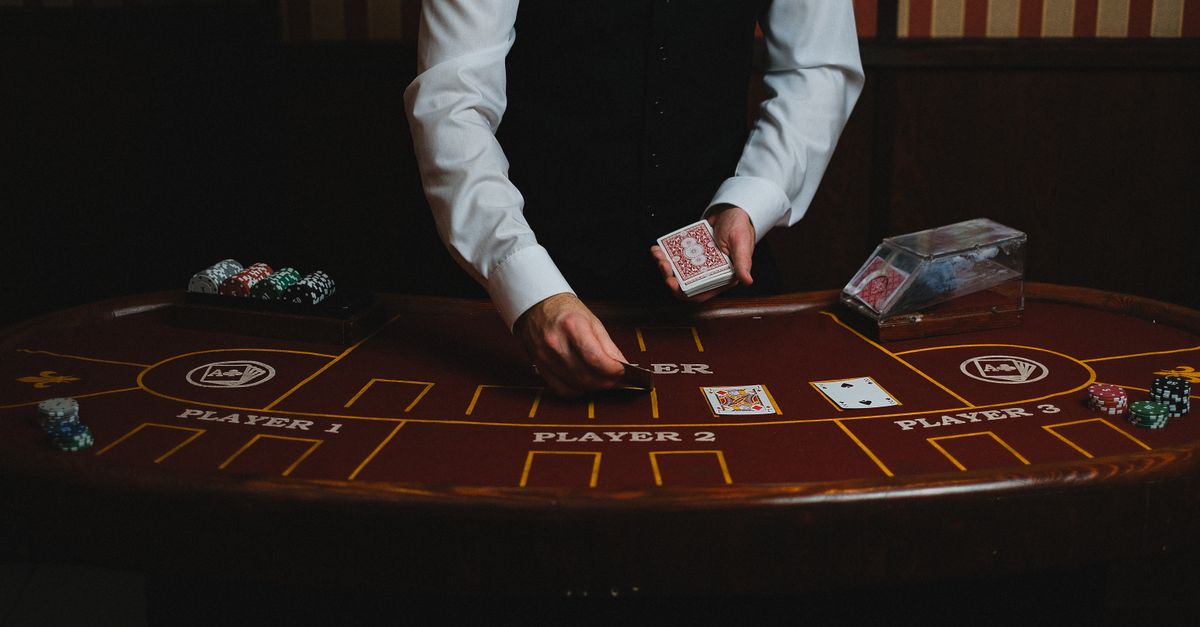 A casino dealer handling cards at a gaming table, ready for blackjack or poker.